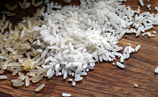 A close up of grains of rice scattered on the counter.